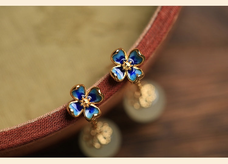Flower Four Leaf Clover Ear Studs with blue gemstones and gold plating, perfect for stylish outfits.