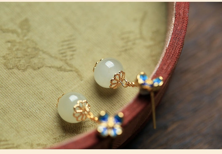 flower four leaf clover ear studs with gold plating and artificial gemstones on decorative plate