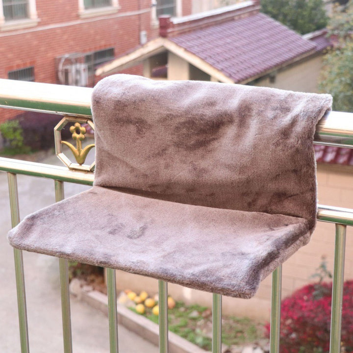Solid steel frame structure super portable cat nest with soft plush fabric on a balcony railing.