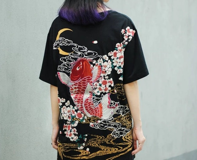Unique embroidered t-shirts collection featuring a vibrant koi fish and floral design on a black background.