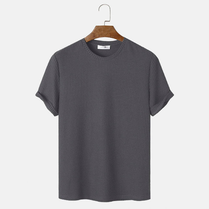 Men summer solid color t-shirts in dark grey with short sleeves on a hanger.