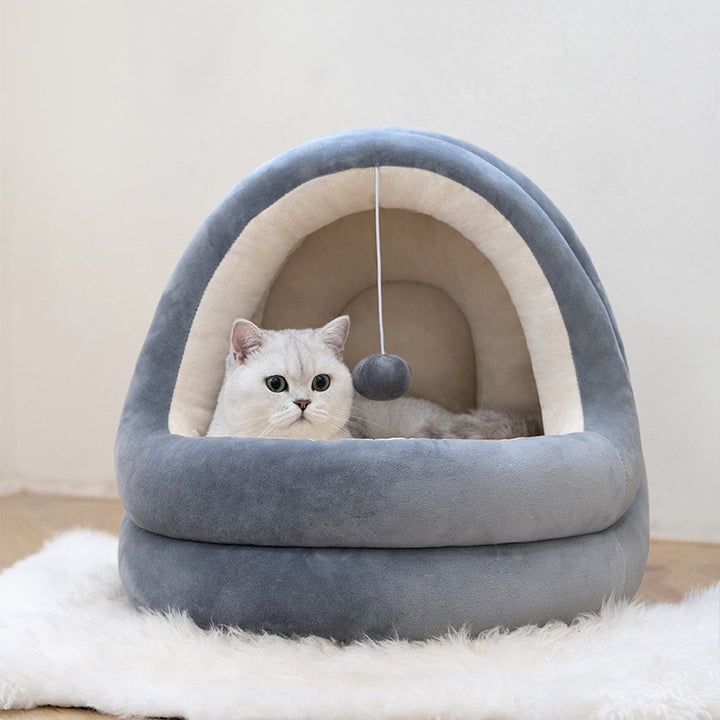 high quality cat house beds featuring a cozy, soft, gray bed with a playful toy and a relaxed cat inside.