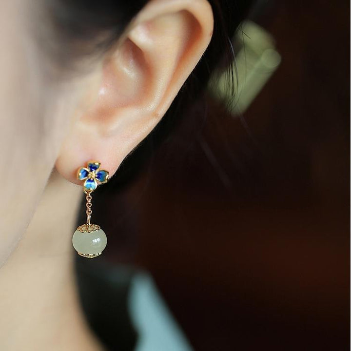 Flower Four Leaf Clover Ear Studs showcasing a blue flower design with a dangling gemstone.