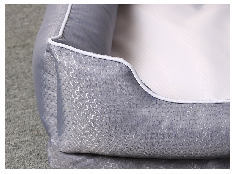 Close-up of a removable dog bed for pets with a hexagonal pattern in soft grey fabric.