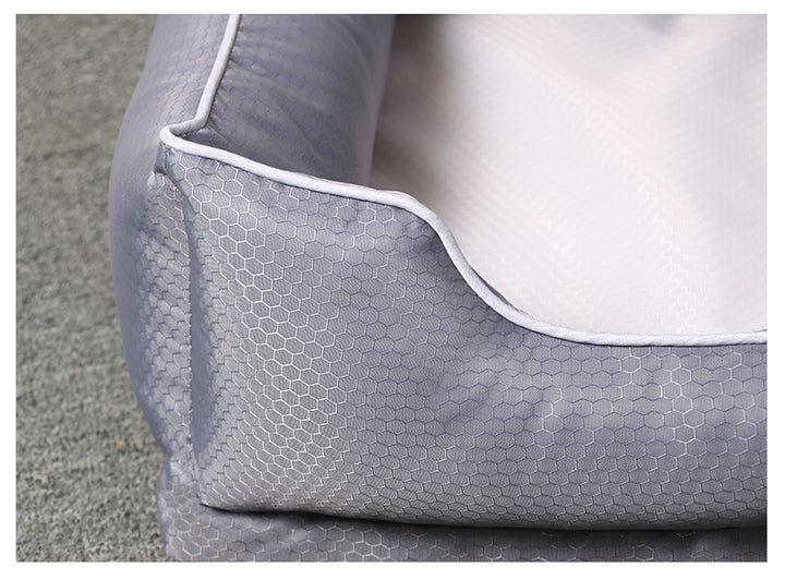 Close-up of a removable dog bed for pets with a hexagonal pattern in soft grey fabric.