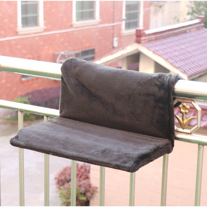 Super portable cat nest with soft dark gray plush fabric, perfect for cats on a balcony.