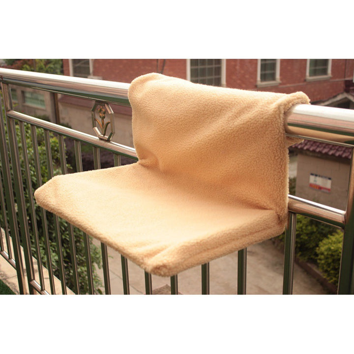 Solid steel frame structure super portable cat nest with plush fabric on a balcony railing.