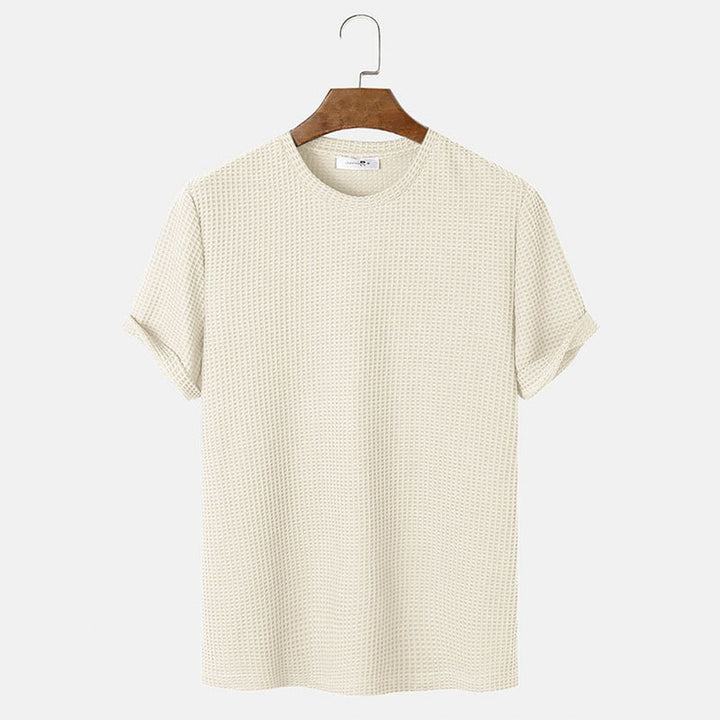 Men summer solid color t-shirts in beige hanging on a wooden hanger, featuring a comfortable crew neck design.